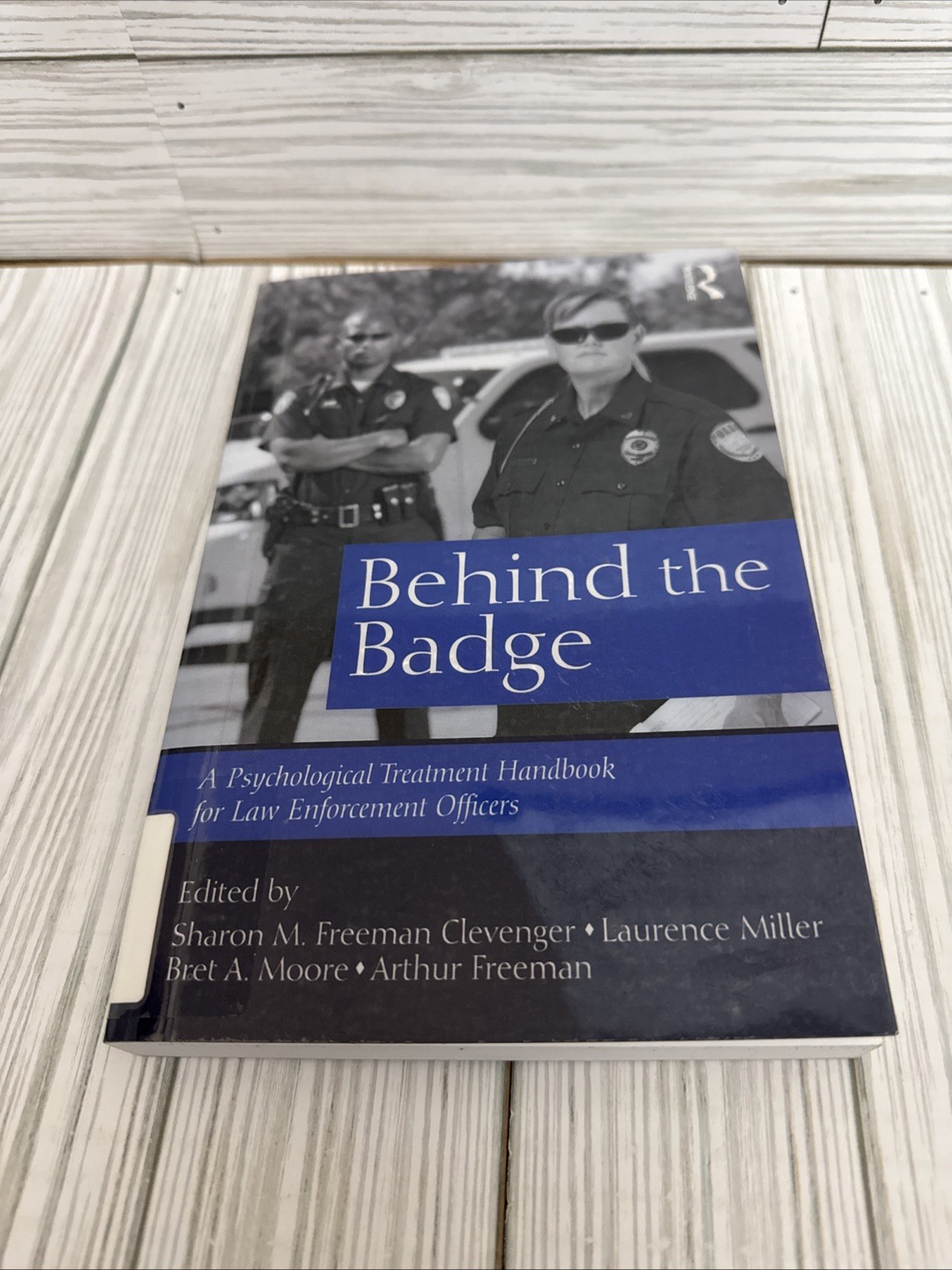 Behind the Badge – Paperback, by M. Freeman Clevenger Sharon – Good